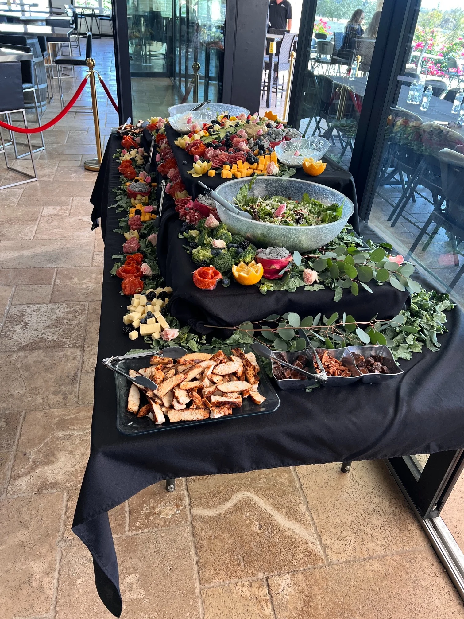 Catered grazing spread with salad and charcuterie
